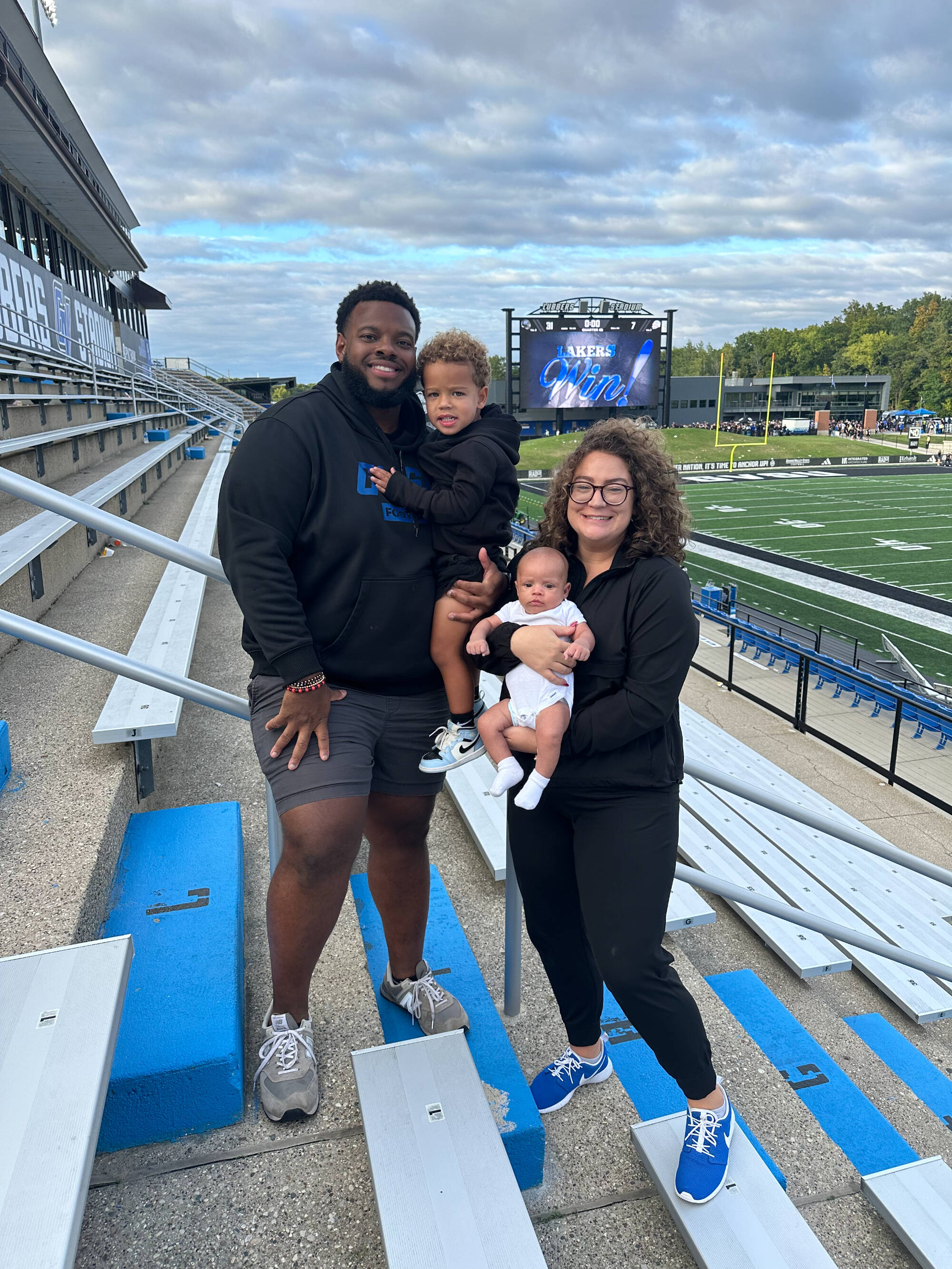A Laker family smiles in the stands of Lubbers Stadium after a game